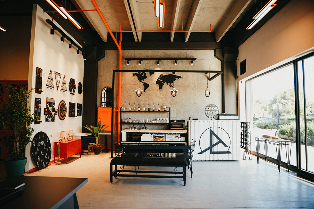 Modern café interior featuring a stylish decor, map art, and large windows with natural light.