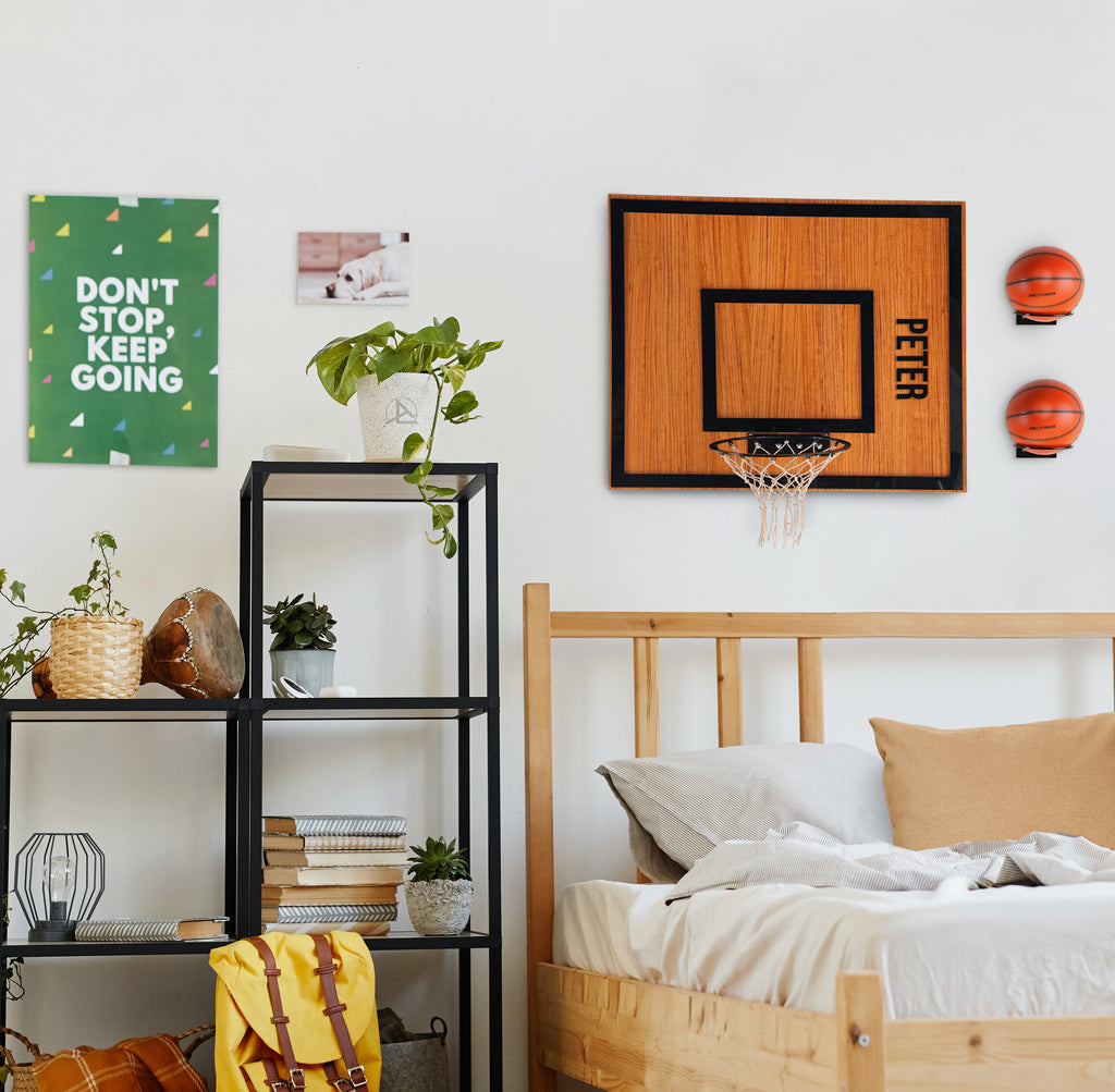 Personalized wooden single hoop and mini basketballs on a bedroom wall, adding entertainment and style.