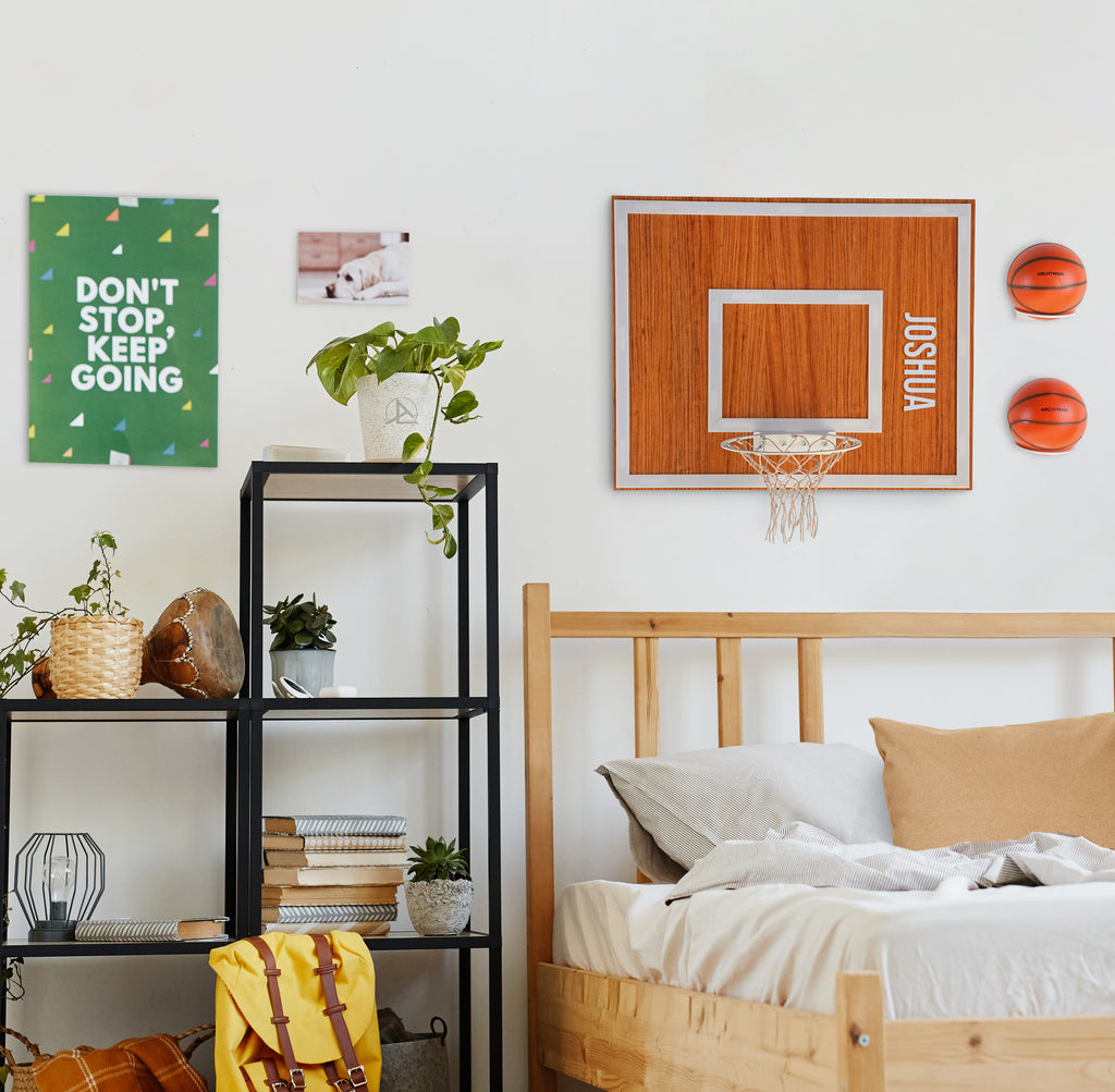 Personalized wooden hoop and wall decor in a stylish bedroom with vibrant motivational poster.