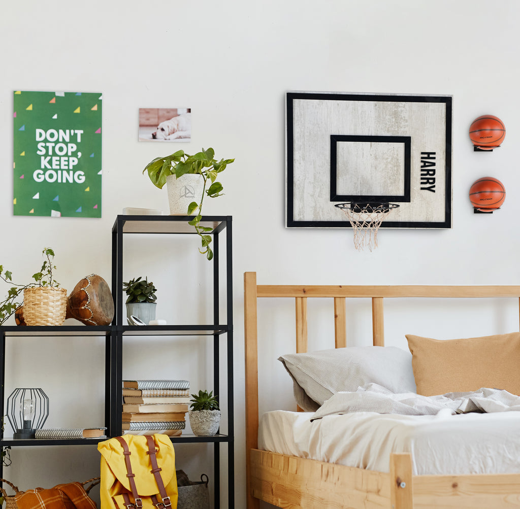 Stylish bedroom with wooden decor, wall-mounted basketball hoops, and motivational artwork.