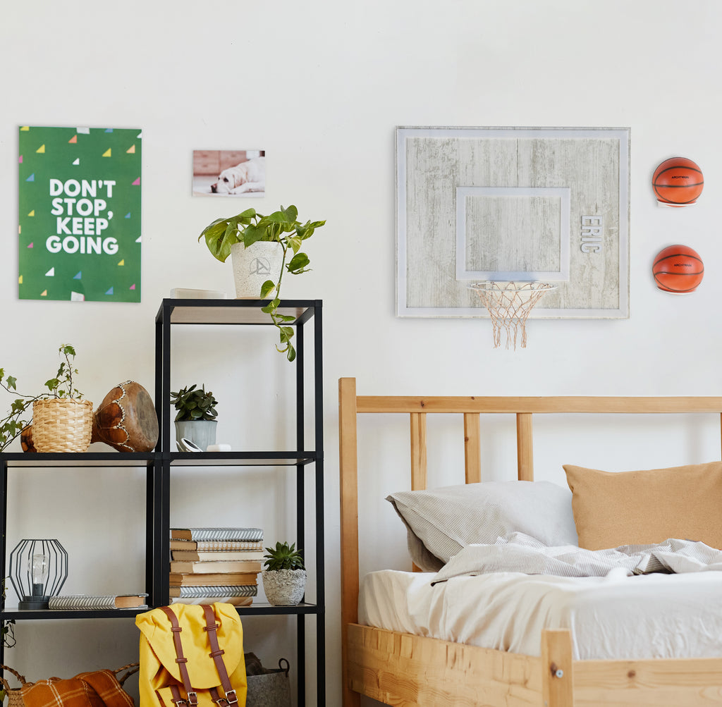 Cozy bedroom featuring wooden single hoop basketball decor and motivational wall art.